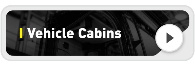 A button labeled "Vehicle Cabins" with a play icon on the right, set against a dark background showing part of a vehicle interior.